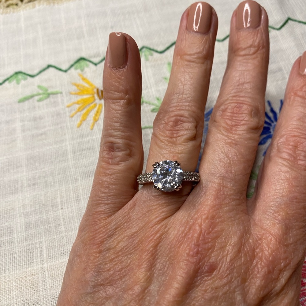 Faux diamond engagement ring. Silver tone eternity band.